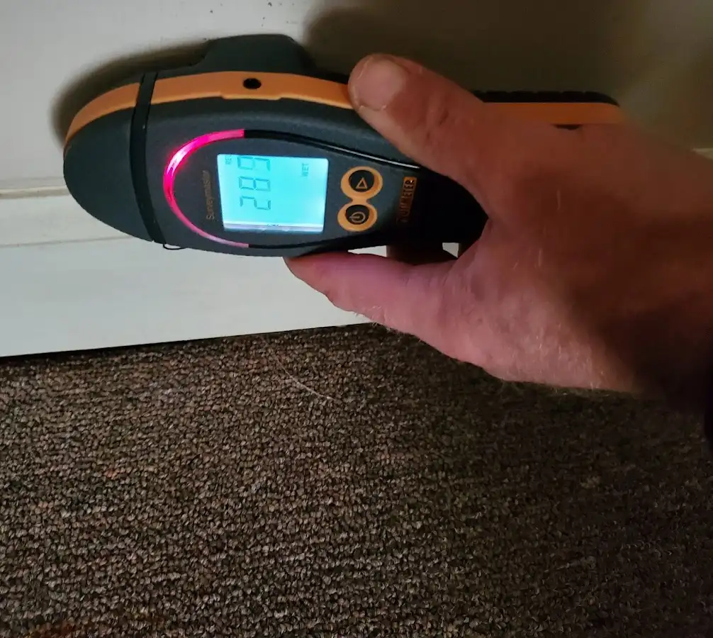 Moisture detection at baseboard during Storm Damage Restoration in Herndon